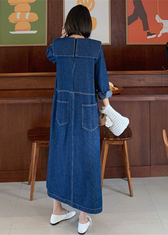 Fashionable denim patchwork dress with blue button accents, peter pan collar, and practical pockets, for a comfortable and stylish everyday look