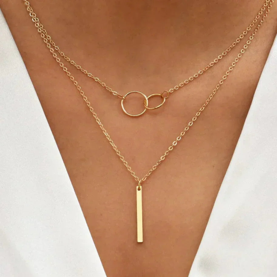 Unique necklace pendant with two rings and vintage aesthetics in gold with jasmine