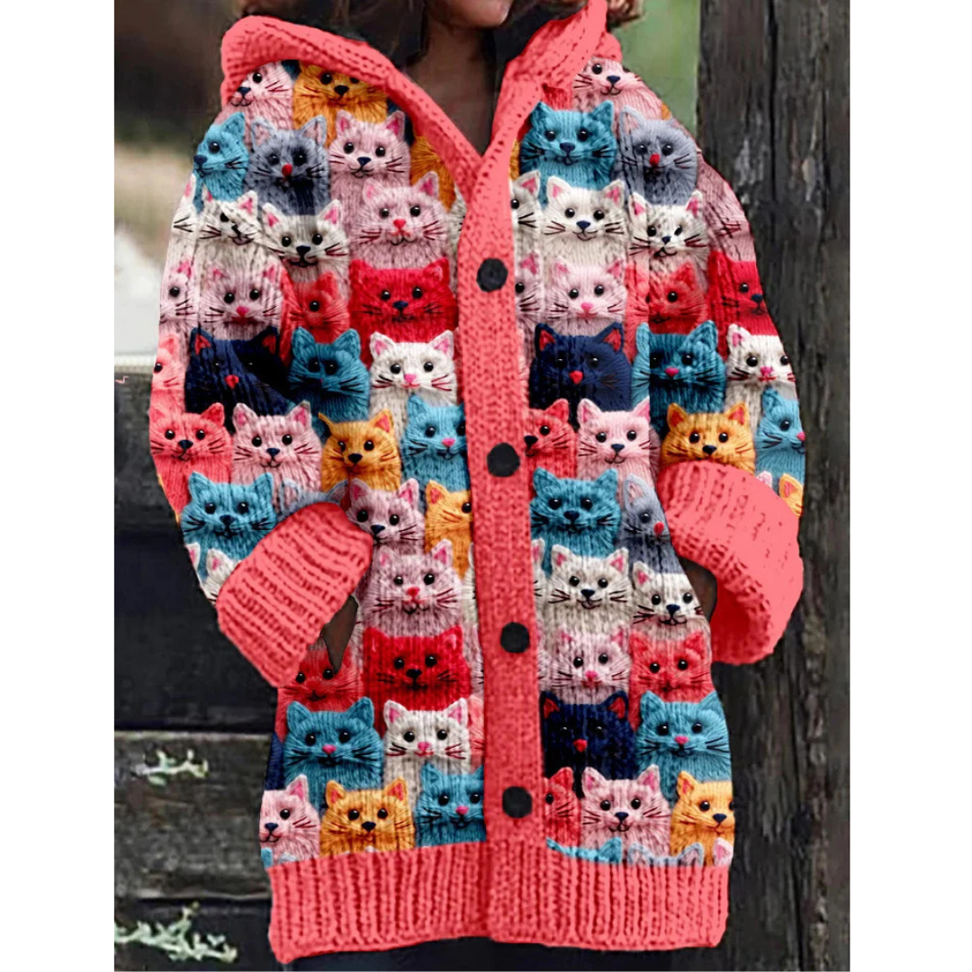 Warm knitted women's jacket with hoodie and cat pattern – stylish design, button closure, and feather insulation for a chilly day