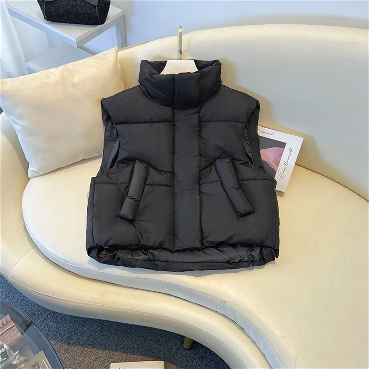 Elegant women's sleeveless top with a high collar and buttons โ stylish and warm feeling
