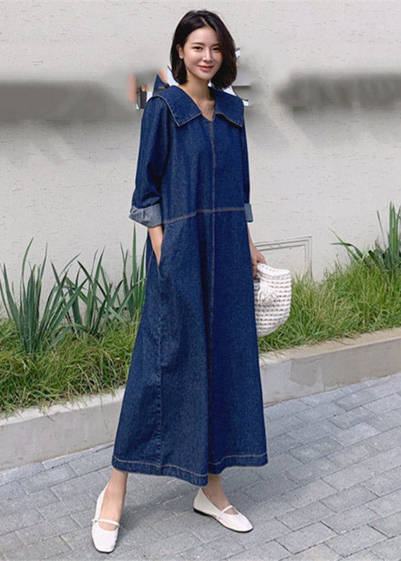 Fashionable denim patchwork dress with blue button accents, peter pan collar, and practical pockets, for a comfortable and stylish everyday look
