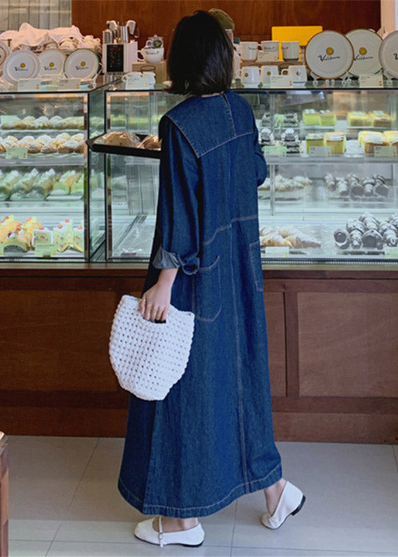 Fashionable denim patchwork dress with blue button accents, peter pan collar, and practical pockets, for a comfortable and stylish everyday look