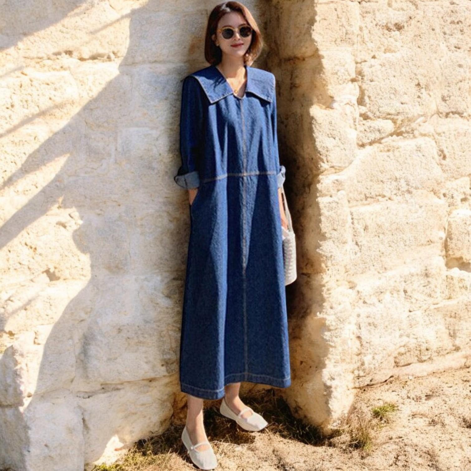 Fashionable denim patchwork dress with blue button accents, peter pan collar, and practical pockets, for a comfortable and stylish everyday look