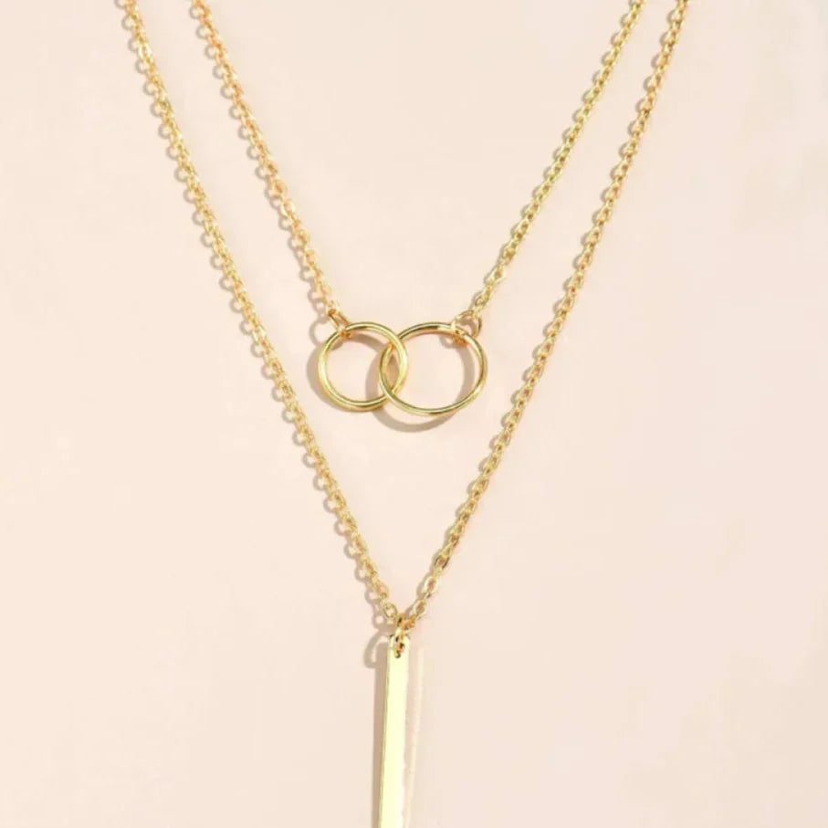Unique necklace pendant with two rings and vintage aesthetics in gold with jasmine