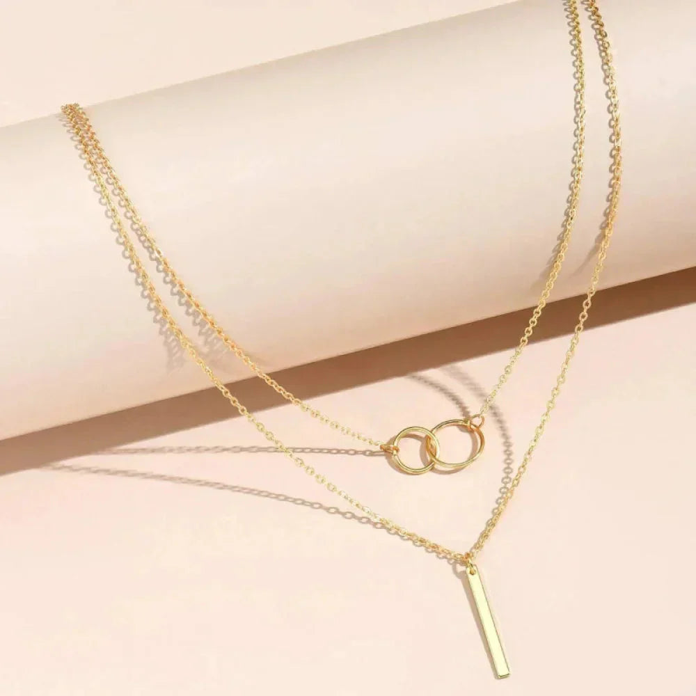 Unique necklace pendant with two rings and vintage aesthetics in gold with jasmine