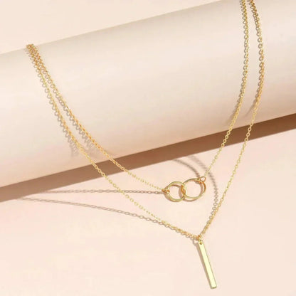 Unique necklace pendant with two rings and vintage aesthetics in gold with jasmine
