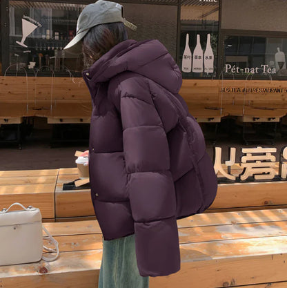 Elegant women's statement in a black puffer coat with a practical hat for a perfect style