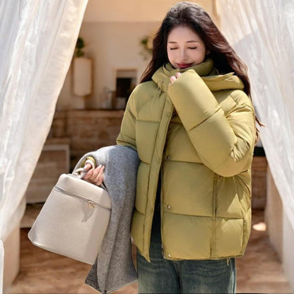 Elegant women's statement in a black puffer coat with a practical hat for a perfect style