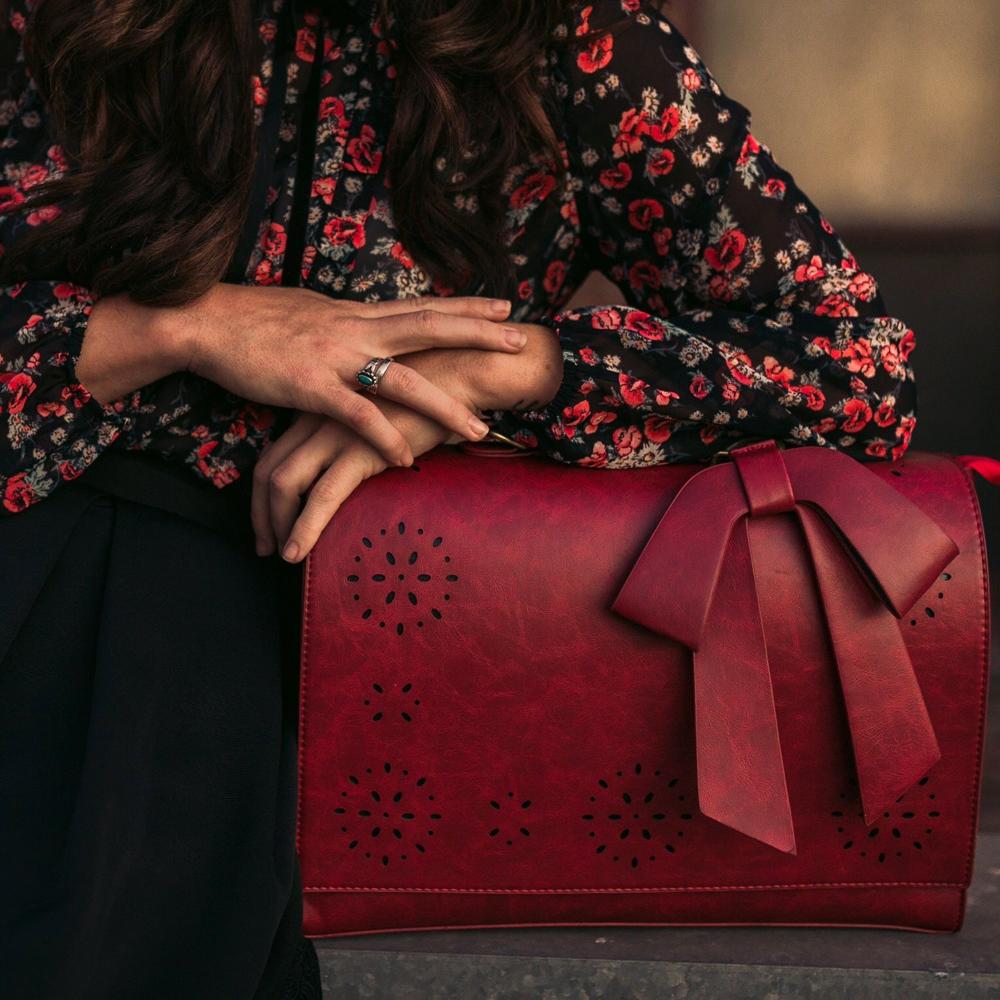 Fashionable bag with a unique and attractive feather ornament by Grace
