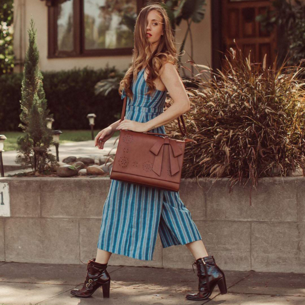Fashionable bag with a unique and attractive feather ornament by Grace