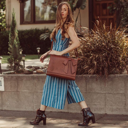 Fashionable bag with a unique and attractive feather ornament by Grace