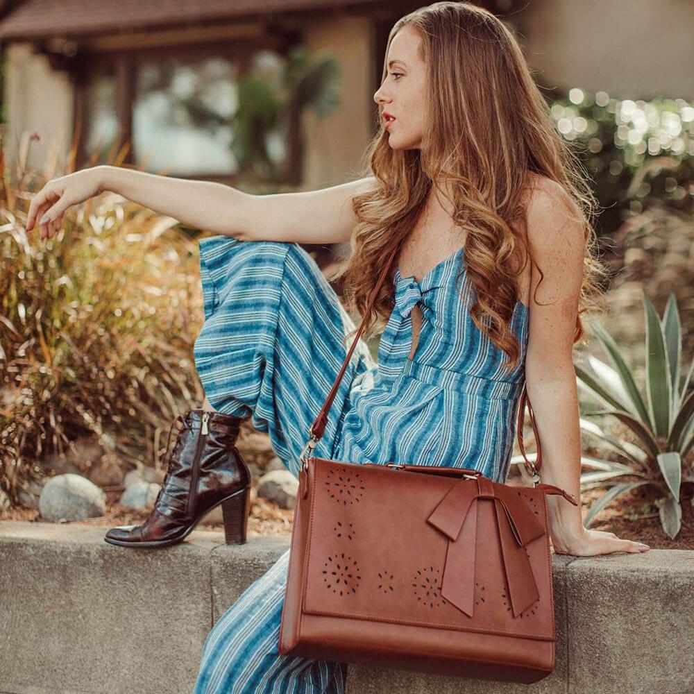Fashionable bag with a unique and attractive feather ornament by Grace