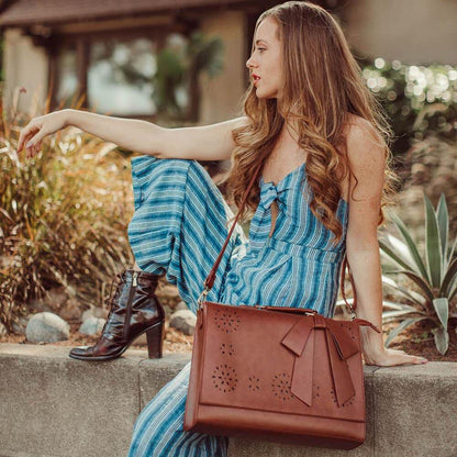 Fashionable bag with a unique and attractive feather ornament by Grace