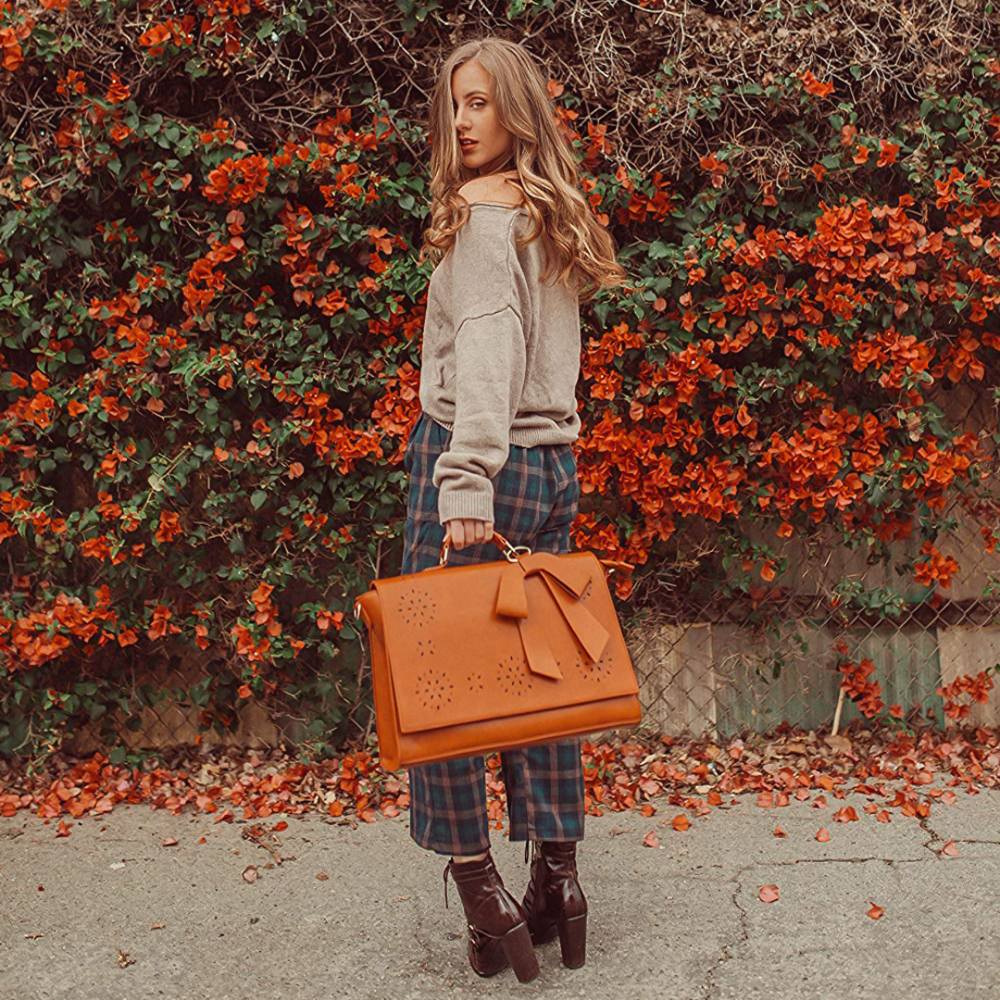 Fashionable bag with a unique and attractive feather ornament by Grace
